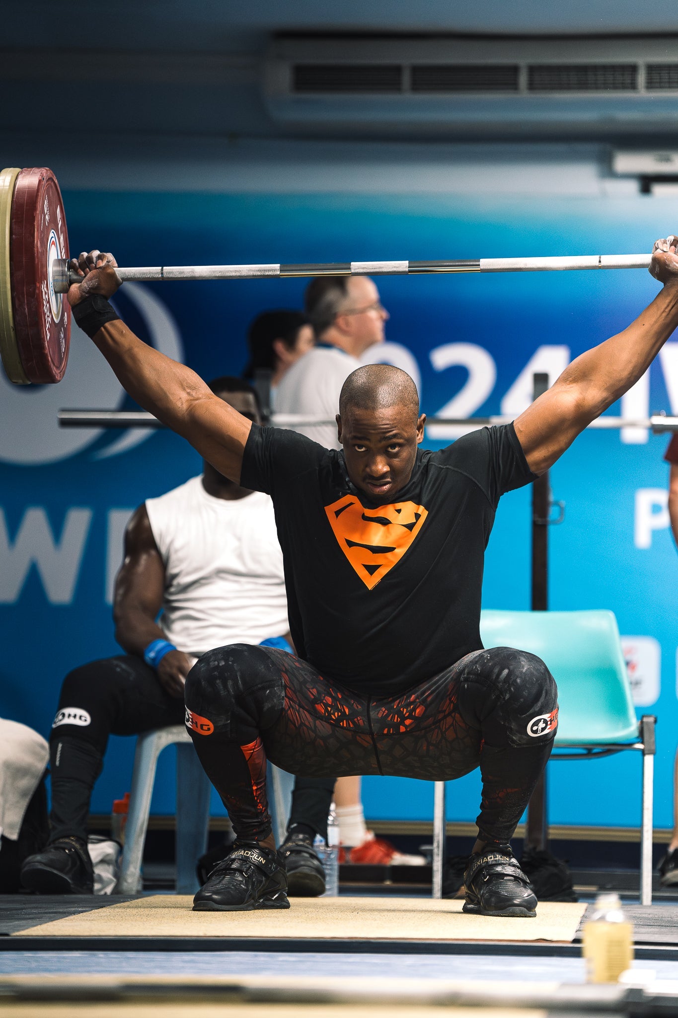 Lesman Paredes, Bahraini weightlifter, lifts a heavy barbell